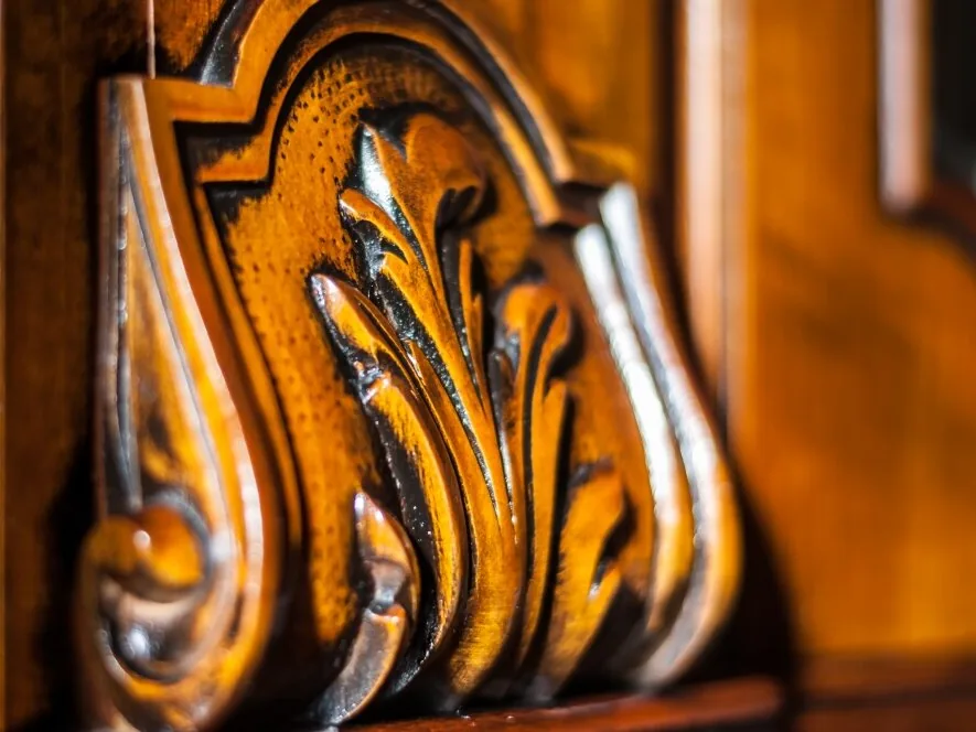 Carved antique wood detail being hand finished
